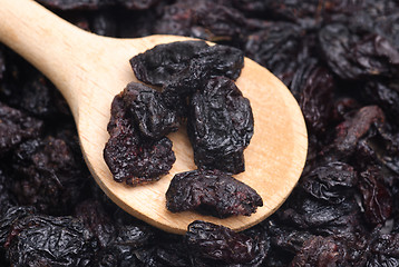 Image showing raisins and  wooden  spoon close- up food background 