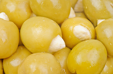 Image showing Green olives stuffed with almonds  as  food  background