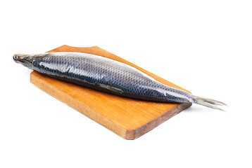 Image showing herring on wooden hardboard isolated on white background 