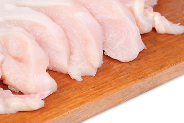 Image showing chicken meat sliced   on  cutting  board isolated  on  white  background