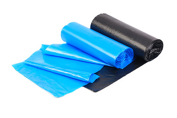 Image showing roll of blue and  black garbage bags on a white background 