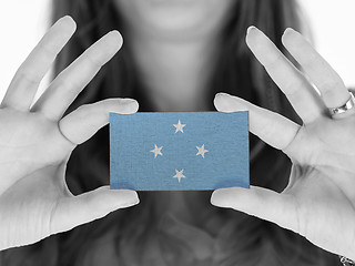 Image showing Woman showing a business card