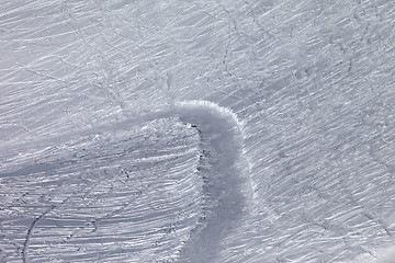 Image showing Off-piste slope and snowy road with trace from ski and snowboard