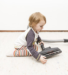 Image showing young child cleaning vacuum cleaner