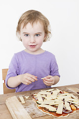 Image showing cute girl making fresh pizza