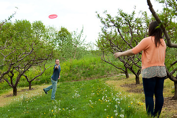 Image showing Couple Playing Frisbee Together