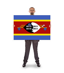 Image showing Smiling businessman holding a big card or flag