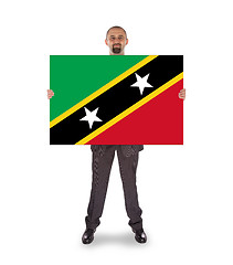 Image showing Smiling businessman holding a big card or flag