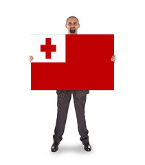 Image showing Smiling businessman holding a big card or flag