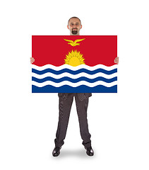 Image showing Smiling businessman holding a big card or flag