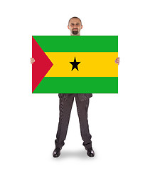 Image showing Smiling businessman holding a big card or flag