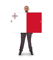 Image showing Smiling businessman holding a big card or flag