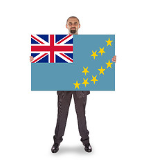 Image showing Smiling businessman holding a big card or flag