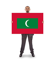 Image showing Smiling businessman holding a big card or flag