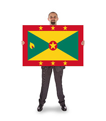 Image showing Smiling businessman holding a big card or flag