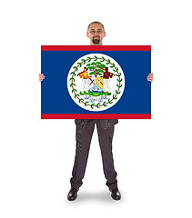 Image showing Smiling businessman holding a big card or flag