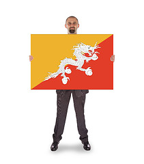 Image showing Smiling businessman holding a big card or flag