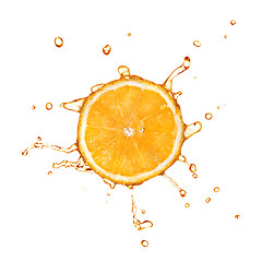 Image showing Slice of orange with juice splash isolated on white