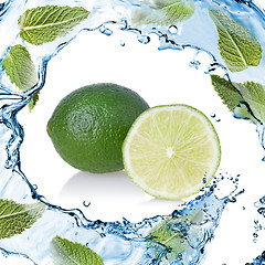 Image showing water splash with lime and green mint isolated on white