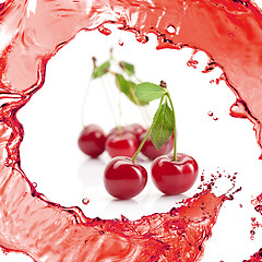 Image showing Red cherry with leaves and juice isolated on white