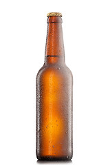 Image showing Beer bottle with water drops and frost isolated on white