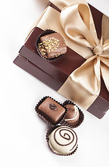 Image showing brown box with candies and golden tape