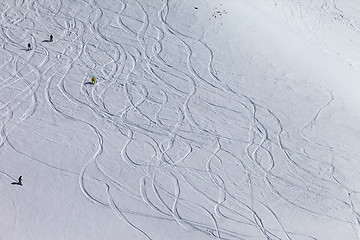 Image showing Snowboarders and skiers on off piste slope