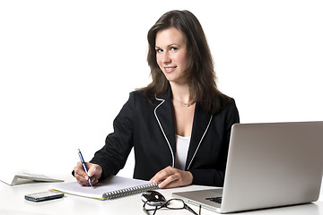 Image showing Smiling businesswoman writing something