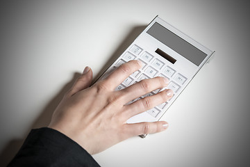 Image showing Female hand with calculator