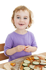 Image showing cute laughing girl making pizza