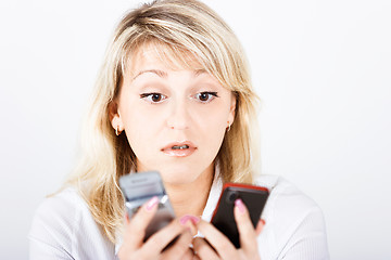 Image showing Portrait girl with two mobile phones