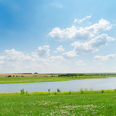 Image showing blue sky over river and green grass