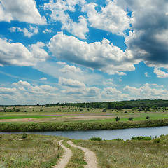 Image showing low clouds and dirty road to river