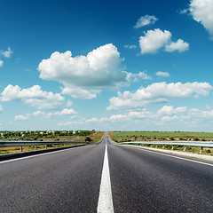 Image showing asphalt road to horizon under cloudy sky