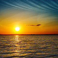 Image showing summer orange sunset over darken sea