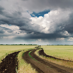 Image showing dirty road in field and dramatic sky