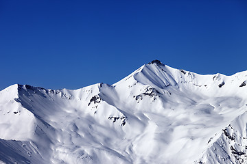 Image showing Off-piste snowy slope and blue clear sky