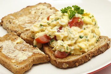 Image showing Scrambled egg with parsley and tomato