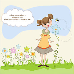 Image showing small young lady who smells a flower