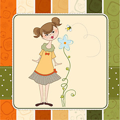 Image showing small young lady who smells a flower