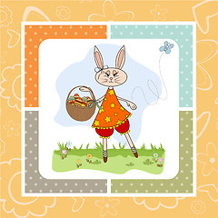 Image showing Easter bunny with a basket of Easter eggs