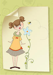 Image showing small young lady who smells a flower