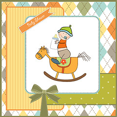 Image showing baby boy shower shower with wood horse toy