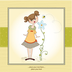 Image showing small young lady who smells a flower