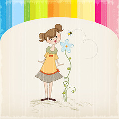 Image showing small young lady who smells a flower
