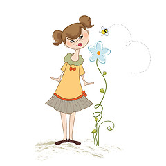 Image showing small young lady who smells a flower