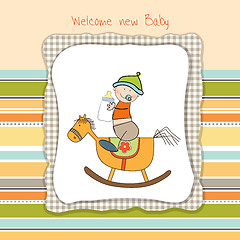 Image showing baby boy shower shower with wood horse toy