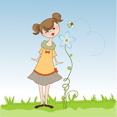 Image showing small young lady who smells a flower