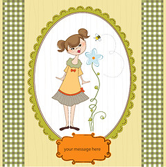 Image showing small young lady who smells a flower