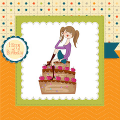 Image showing sexy young woman sitting on a big cake